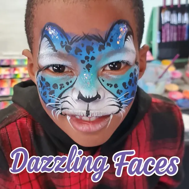 Blue snow leopard face paint on a boy