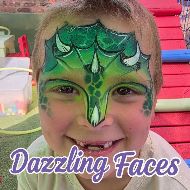Green dinosaur face paint on a boy