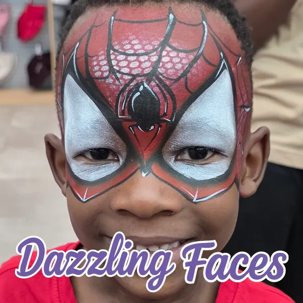 Spider-Man face paint on a smiling boy