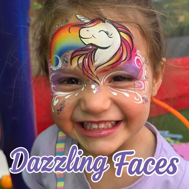 Unicorn and rainbow face paint on a smiling girl