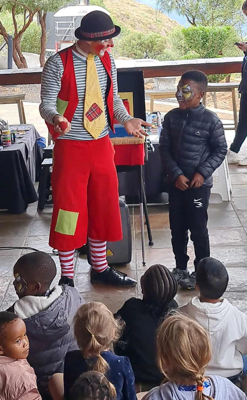 CJ the Clown performing a magic show with a child volunteer