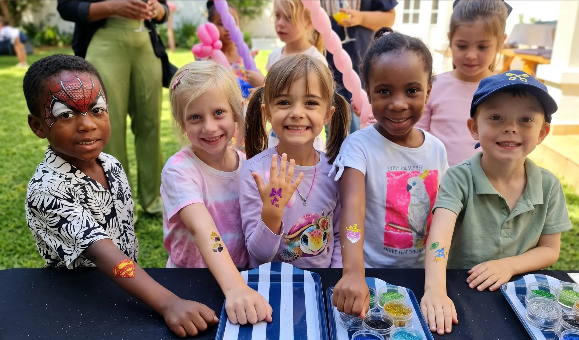 Children showing glitter tattoos on their arms at a party table